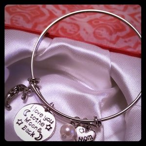 Silver plated bangle with charms.
